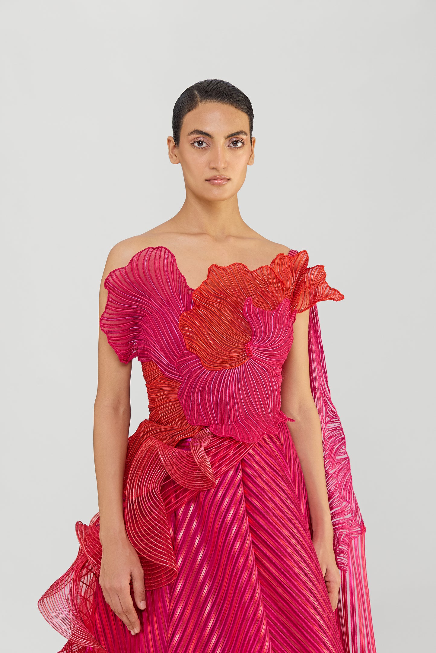 Structured Corded Coral Off The Shoulder Gown With A Metallic Fluted Tulle Skirt And Two Drapes